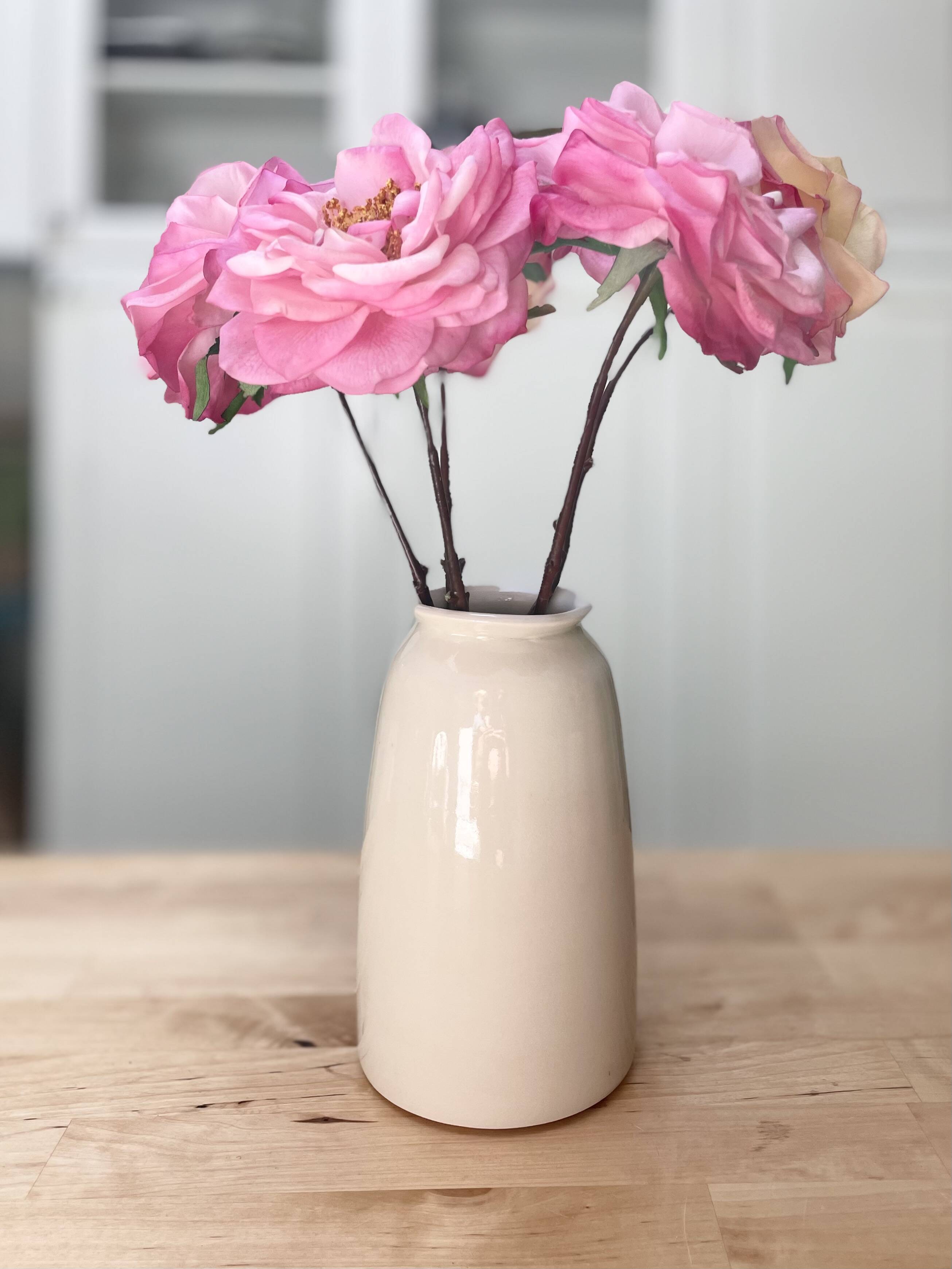 Blush bud vase holding pink ranunculus flowers